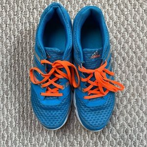 Blue adidas sneakers with neon orange shoelace